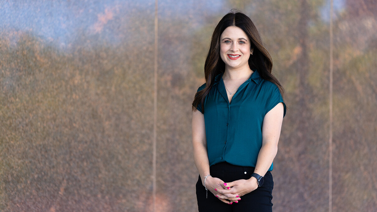 Ciera Kirkpatrick, assistant professor in the College of Journalism and Communications, is photographed by the granite walls outside Andersen Hall.